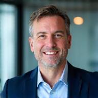 Head Strategist portrait with subtle blue overlays